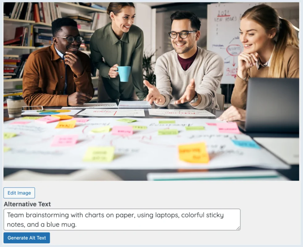 Diverse team discussing over laptops and papers with colorful sticky notes and a blue mug on table.