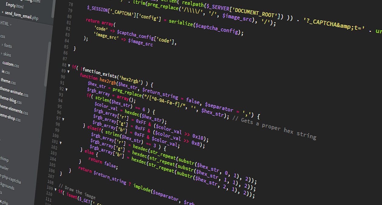 computer screen showing colorful PHP code on dark background with file directory on left side