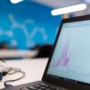 laptop with plastic frame displaying purple data graph on screen