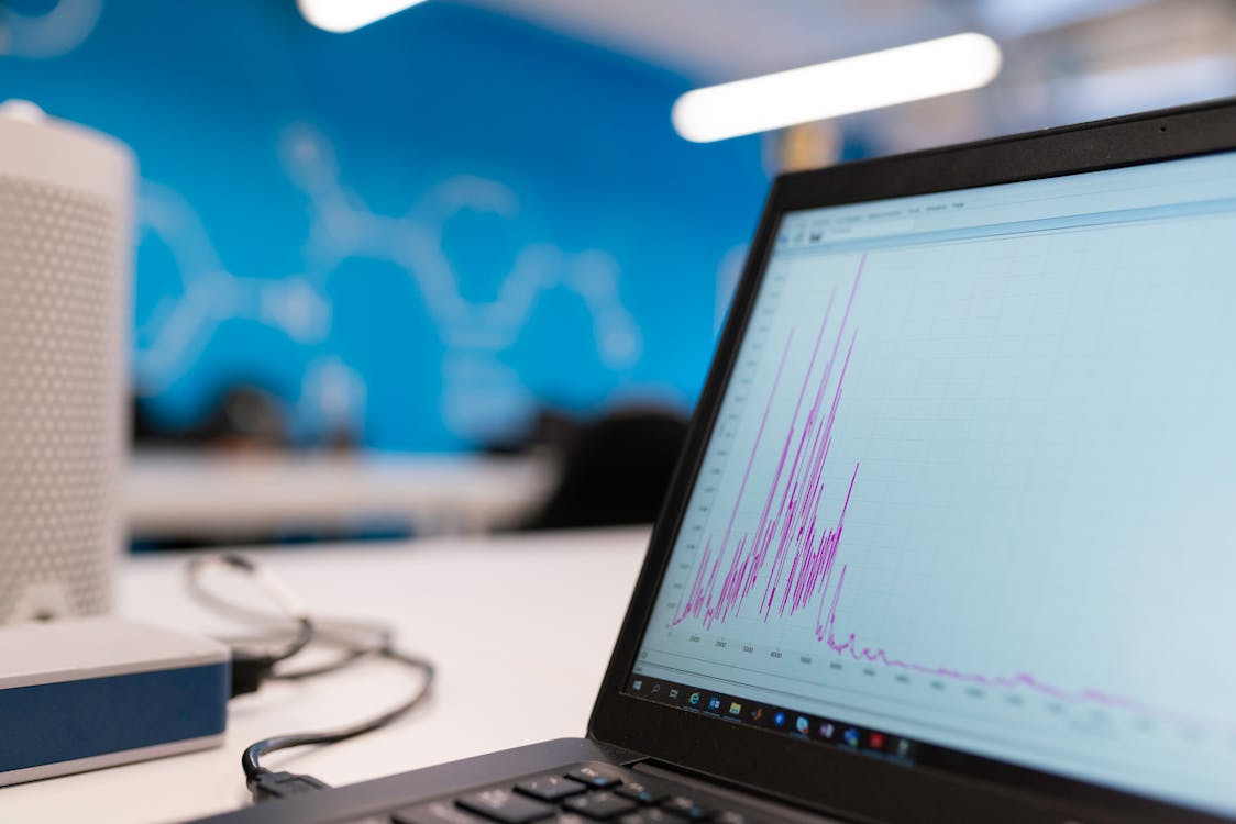 laptop with plastic frame displaying purple data graph on screen