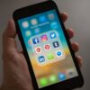 smartphone with plastic case displaying colorful social media app icons on screen