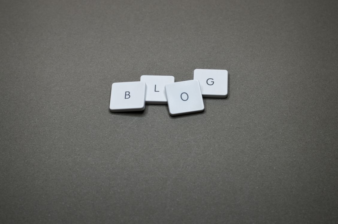 White plastic keyboard keys spelling BLOG on a dark gray textured surface
