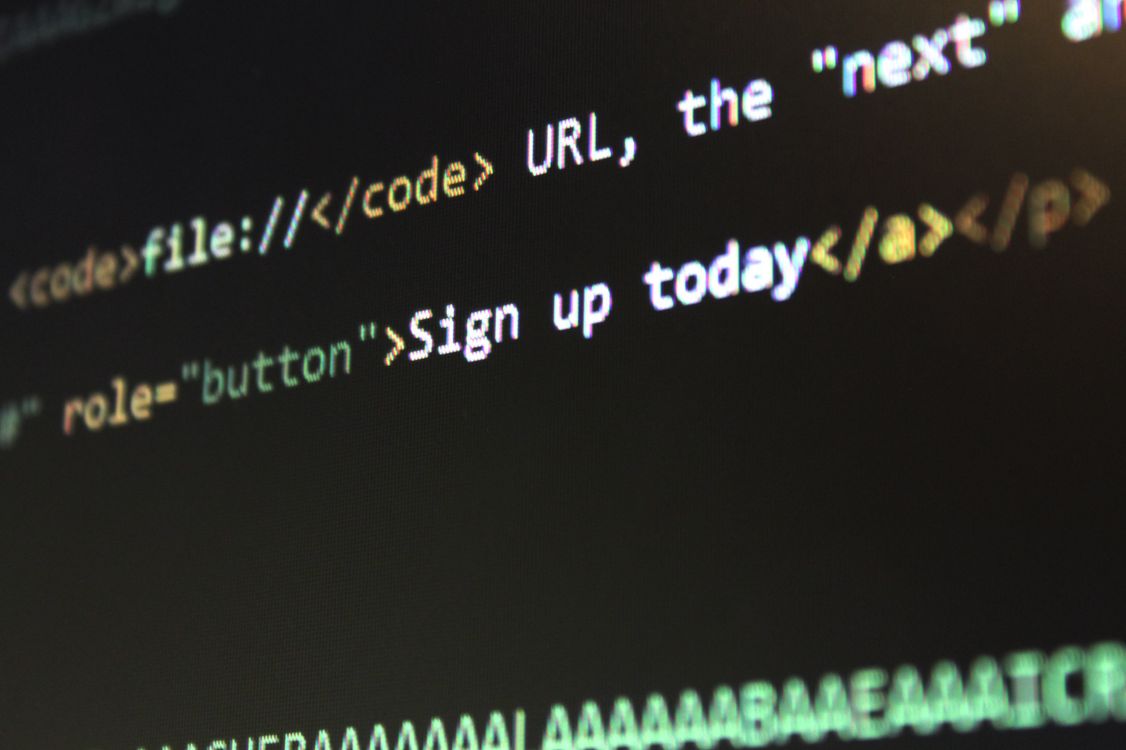 computer screen showing HTML code text on digital display with black background