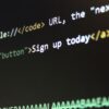 HTML code snippet on black screen showing tags and text in white, green, and yellow colors